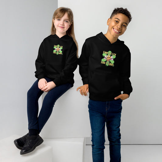A boy standing and a girl sitting both wearing a black kids graphic hoodie with a crazy bee and the statement, Bee Crazy Bee Happy, by Wizard Prints