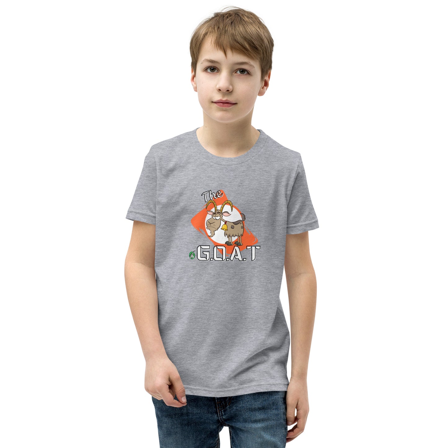 A boy standing wearing a grey kids tee shirt with a graphic of a goat with the word G.O.A.T as in Greatest of all Time by Wizard Prints and jeans on a white background