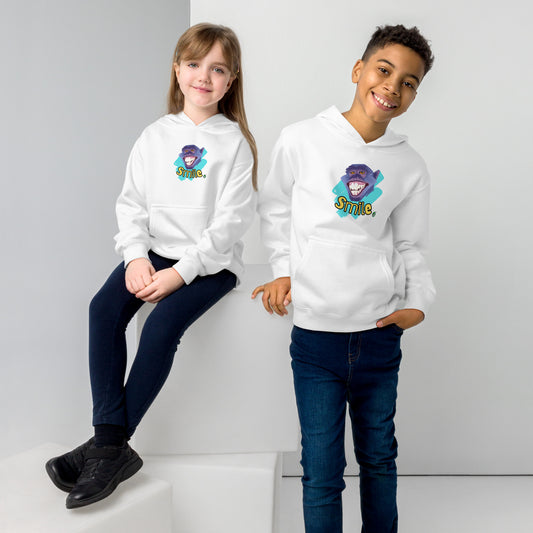 A boy standing and a girl sitting both wearing a white kids graphic hoodie with a smiling monkey face and the word, Smile, by Wizard Prints