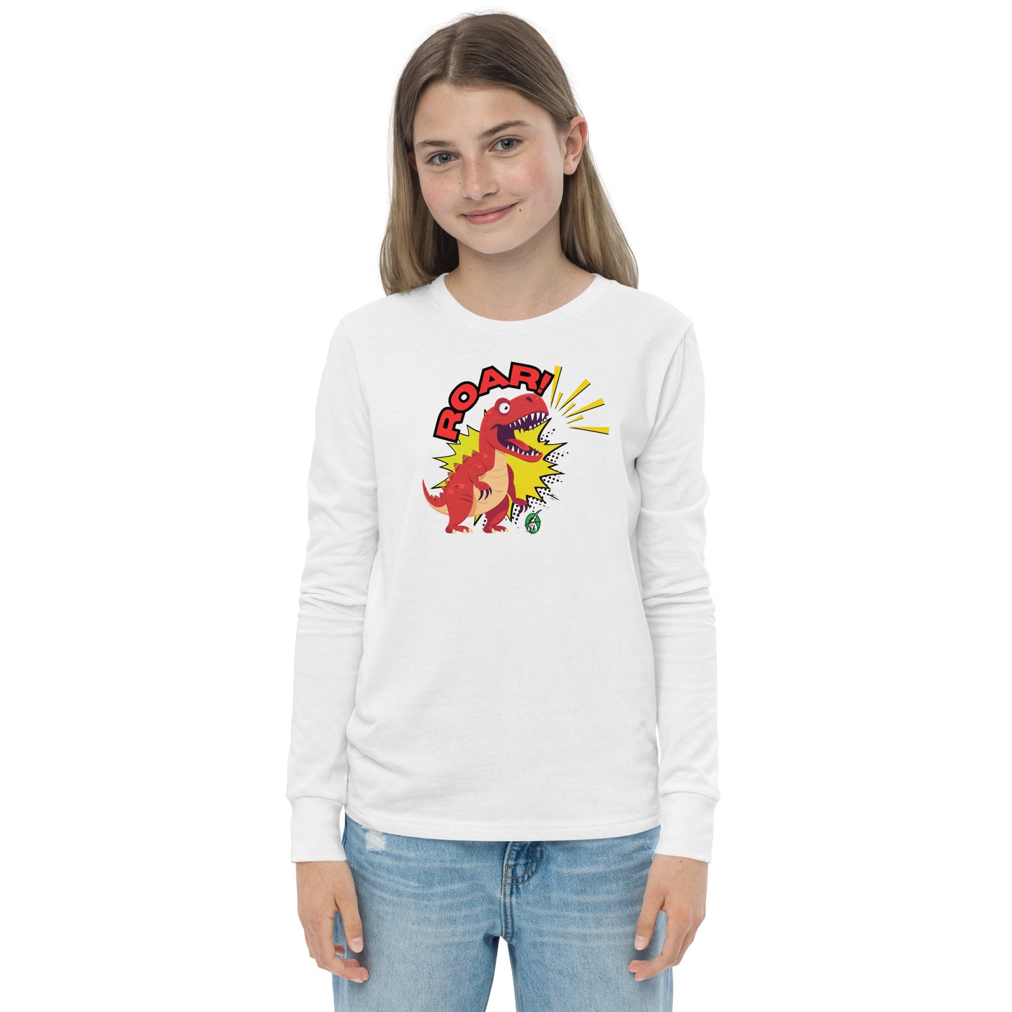 A girl standing and wearing a white long sleeve t-shirt with a printed graphic of a red roaring dinosaur and the word "Roar!", by Wizard Prints.
