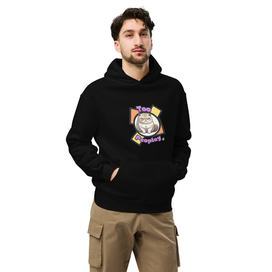 A man standing wearing a black hoodie by Wizard Prints featuring a printed graphic of a grumpy cat with the words, Too Peopley.