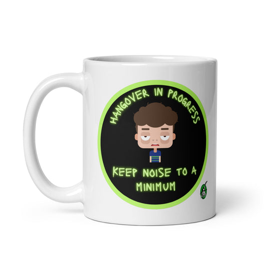 Wizard Prints white graphic mug with a sleepy cartoon character and 'Hangover in progress. Keep noise to a minimum' text on a white background.