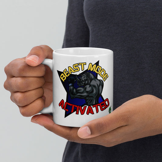 Person holding a Wizard Prints white mug with a graphic design of a rhino and 'Beast Mode Activated' text.