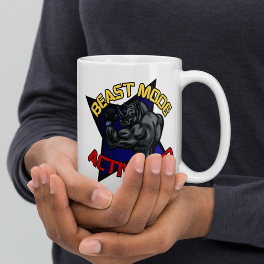 Person holding a Wizard Prints white mug with a graphic design of a rhino and 'Beast Mode Activated' text.