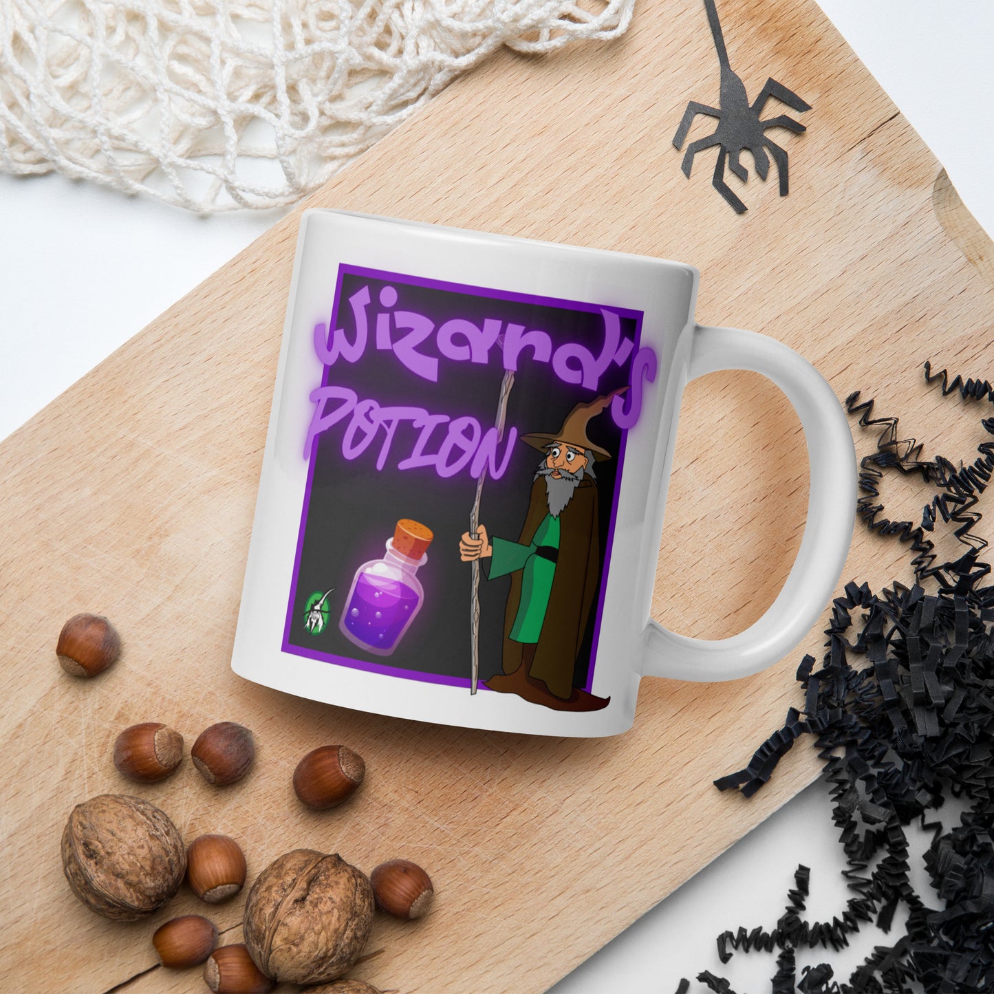 White Wizard Prints mug with cartoon wizard and 'Wizard's Potion' text on a wooden board with nuts and spider decorations