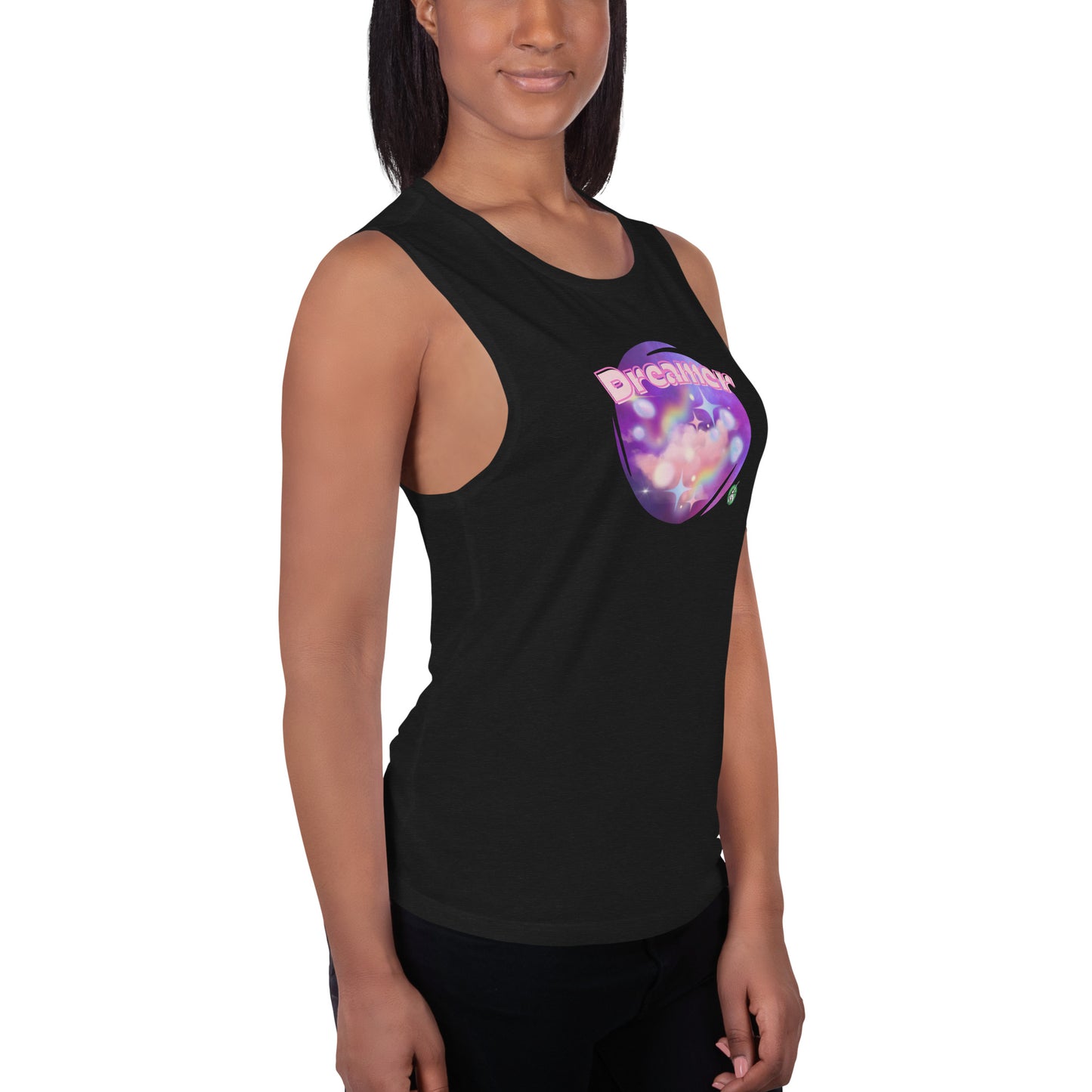 A woman standing wearing a black tank top by Wizard Prints with a printed graphic of a galaxy background and the word Dreamer on top.