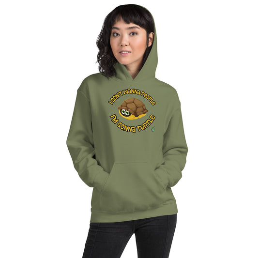 A woman standing wearing a military green hoodie with a printed graphic of a turtle with the words, 'I Don't Wanna People, I'm Gonna Turtle'. Designed by Wizard Prints.