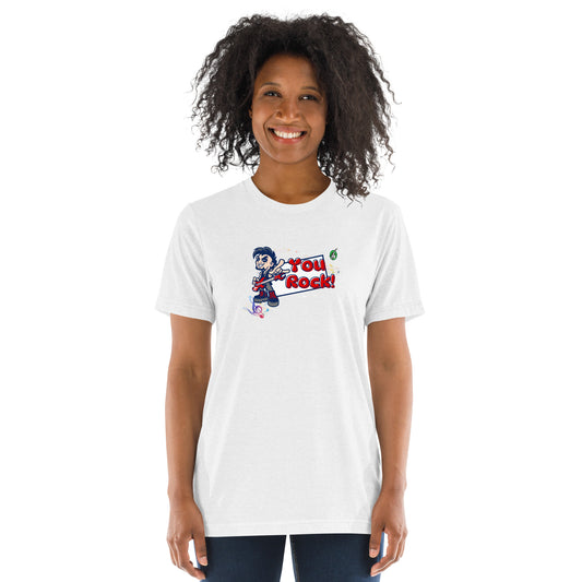 A woman standing wearing a white t-shirt by Wizard Prints featuring a printed graphic of a rock singer holding an electric guitar and the words, You Rock!