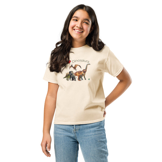 A girl standing and wearing a beige t-shirt featuring a printed graphic of life like dinosaurs and the words, I love Dinosaurs, designed by Wizard Prints.
