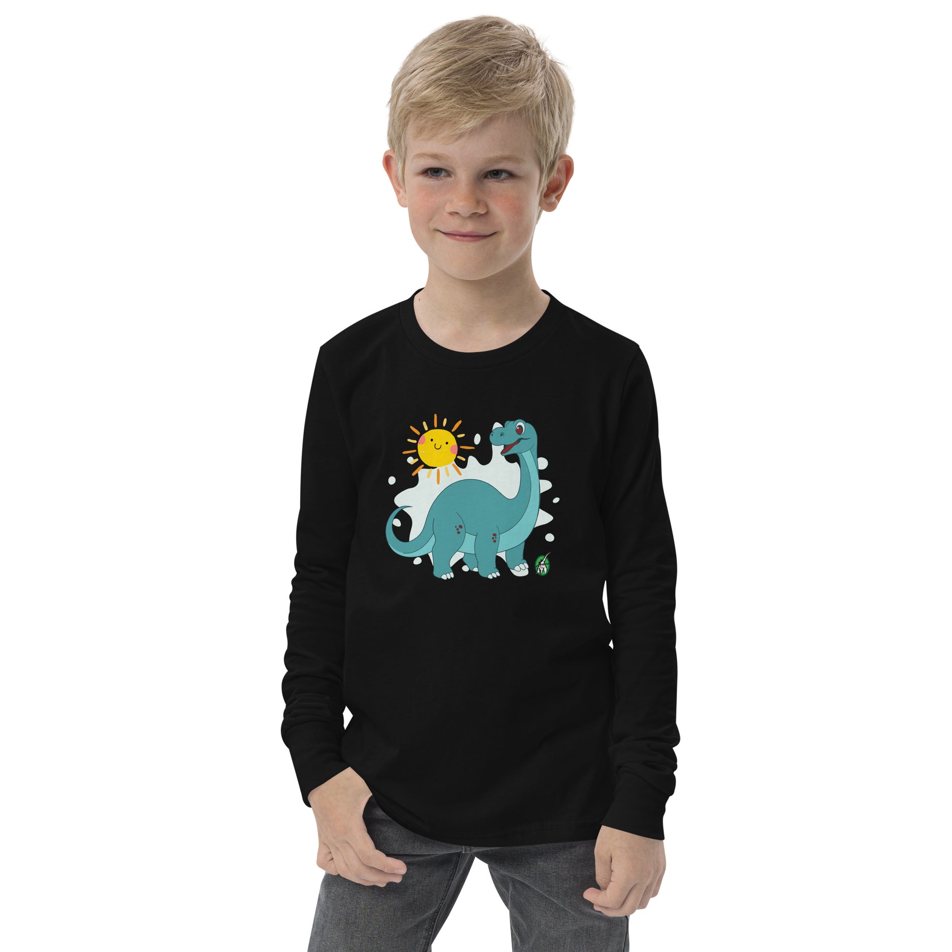 A boy standing and wearing a black long sleeve t-shirt with a printed graphic of a smiling brachiosaurus and the sun. Designed by Wizard Prints