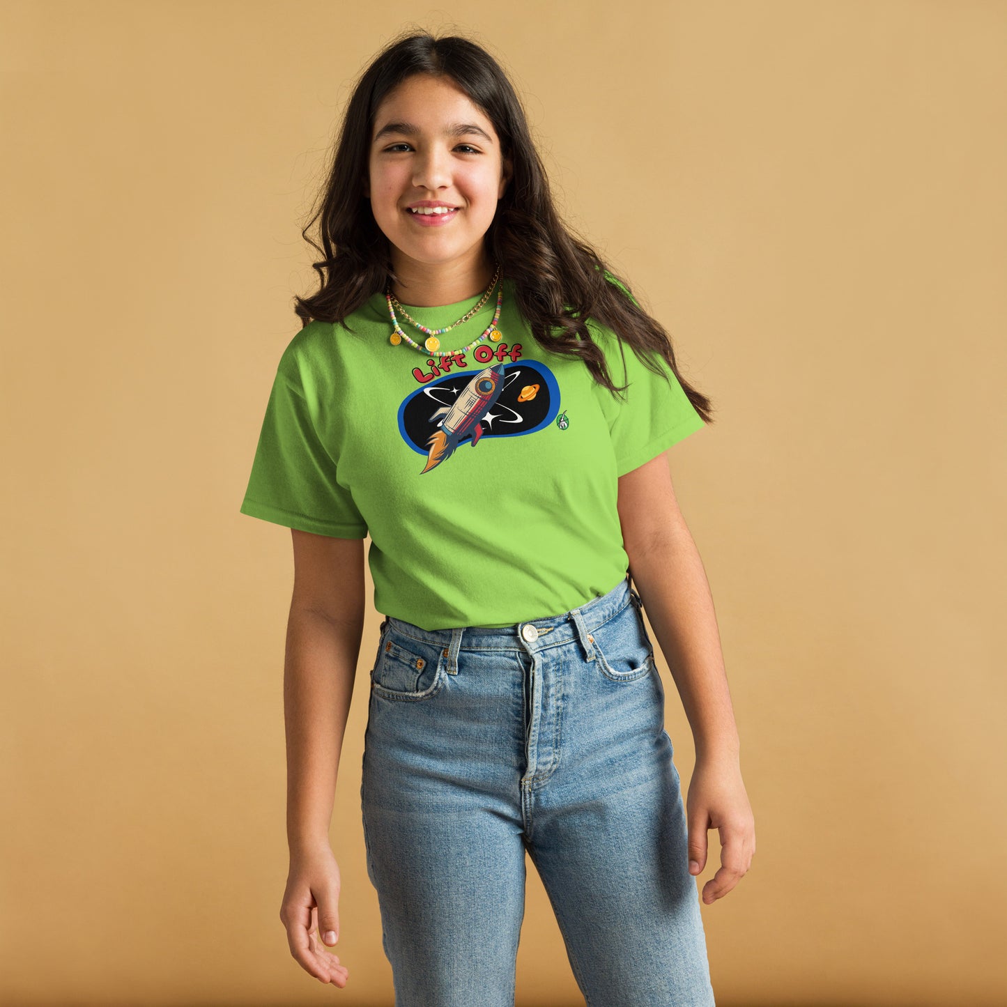 A girl standing and wearing a lime green t-shirt with a printed graphic of a rocket and the words, 'Lift Off'. Designed by Wizard Prints.