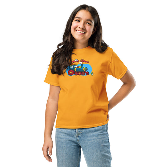 A girl standing and wearing an orange t-shirt featuring a printed graphic of a cartoon train, designed by Wizard Prints.