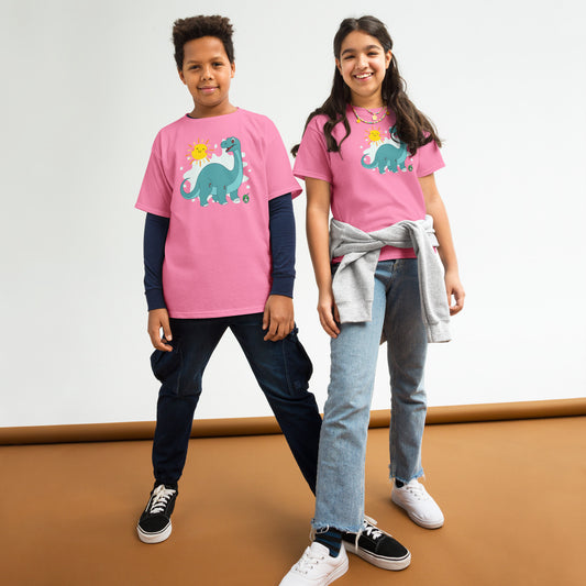 A boy and a girl standing and wearing pink t-shirts with a printed graphic of a smiling cartoon brachiosaurus and the sun. Designed by Wizard Prints.