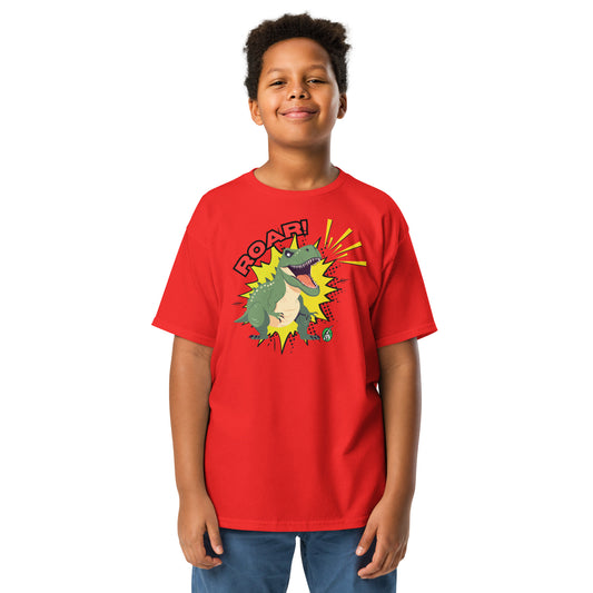 A boy standing and wearing a red t-shirt with a printed graphic of a green roaring dinosaur and the word, Roar!. Designed by Wizard Prints.