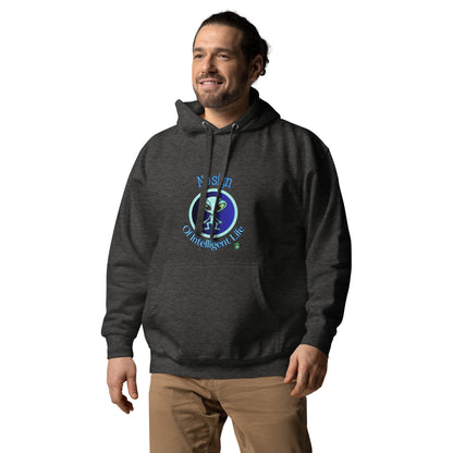 A man standing wearing a dark grey hoodie with a printed graphic of an alien on a blue background with the words, No Sign of Intelligent Life. Designed by Wizard Prints