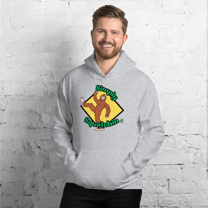 A man standing and wearing a grey hoodie with a printed graphic of a sasquatch with the words, Simply Squatchin. Designed by Wizard Prints.