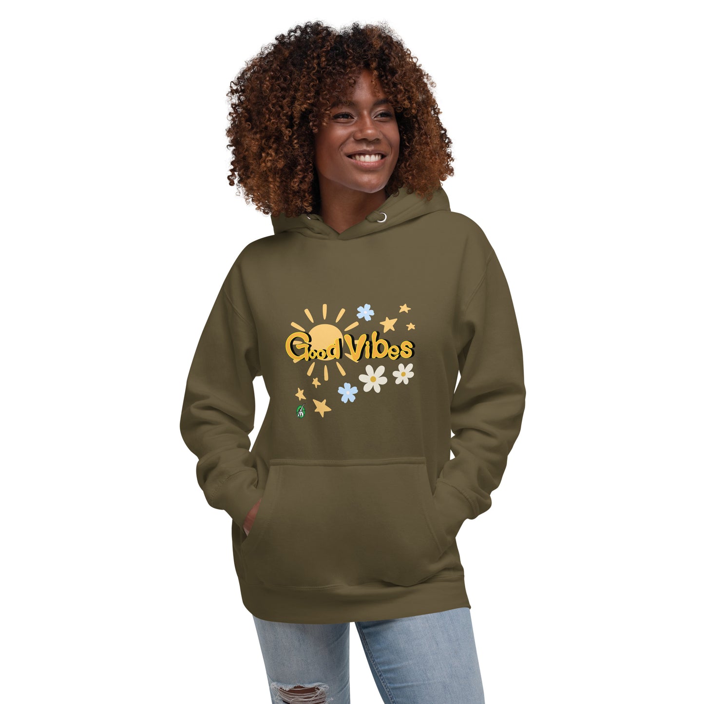 A woman standing wearing a military green hoodie with a printed graphic of the sun with the words, 'Good Vibes'. Designed by Wizard Prints