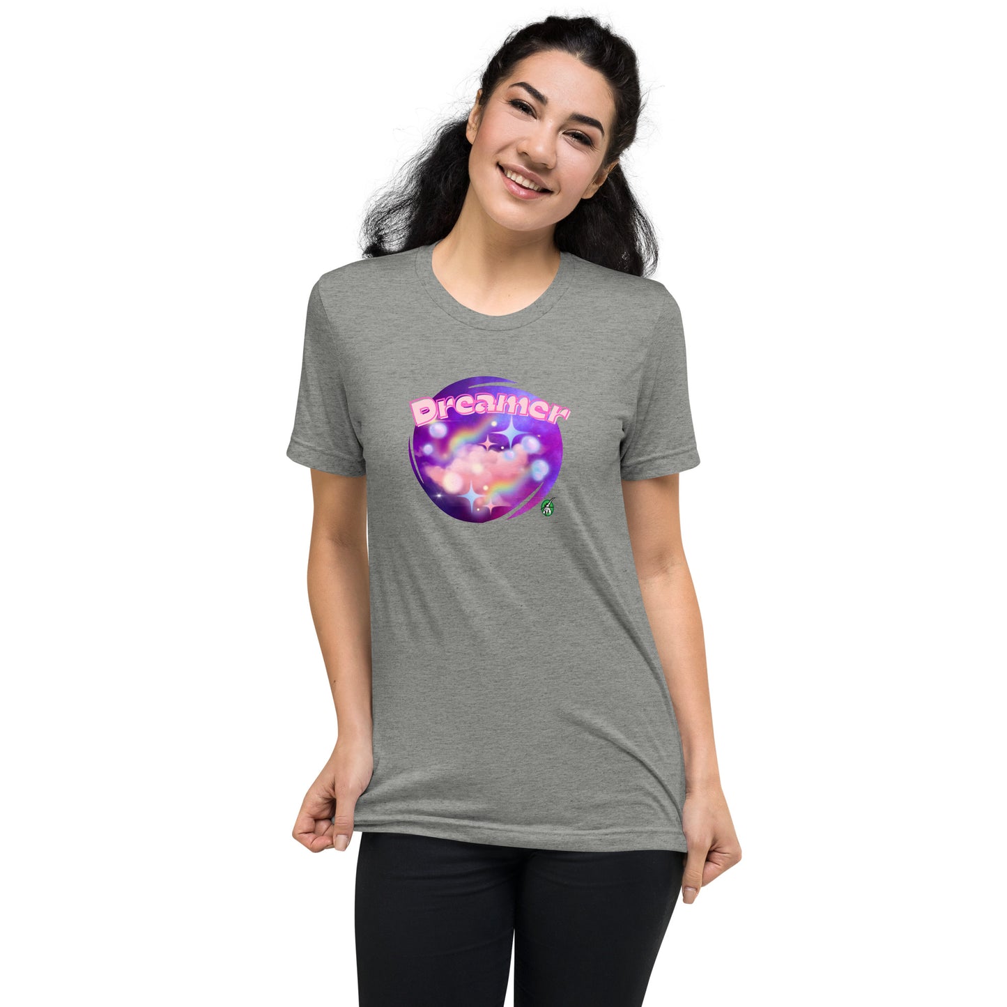A woman standing wearing a grey tee shirt with a printed graphic of a galaxy background and the word Dreamer on top. Designed by Wizard Prints