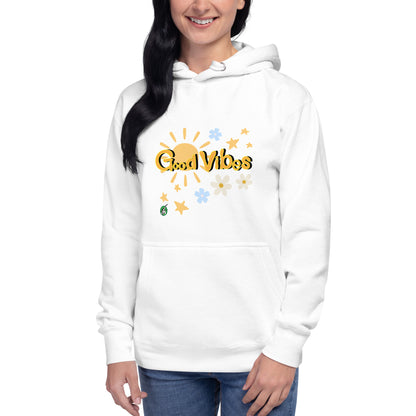 A woman standing wearing a white hoodie with a printed graphic of the sun with the words, 'Good Vibes'. Designed by Wizard Prints