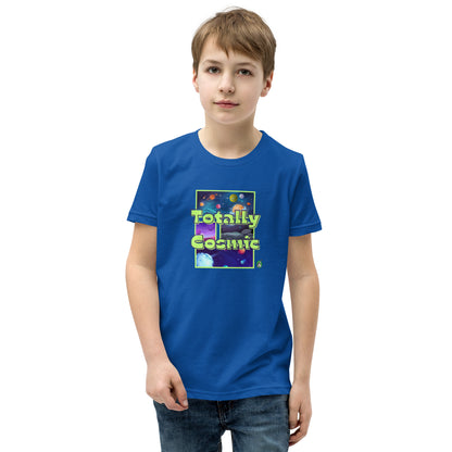 A boy standing wearing a blue kids t-shirt with a graphic of the cosmos and the words Totally Cosmic, by Wizard Prints