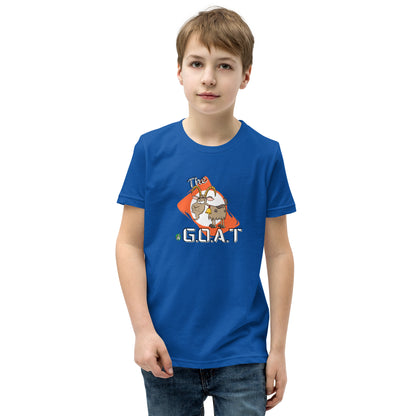 A boy standing wearing a blue kids tee shirt with a graphic of a goat with the word G.O.A.T as in Greatest of all Time by Wizard Prints and jeans on a white background
