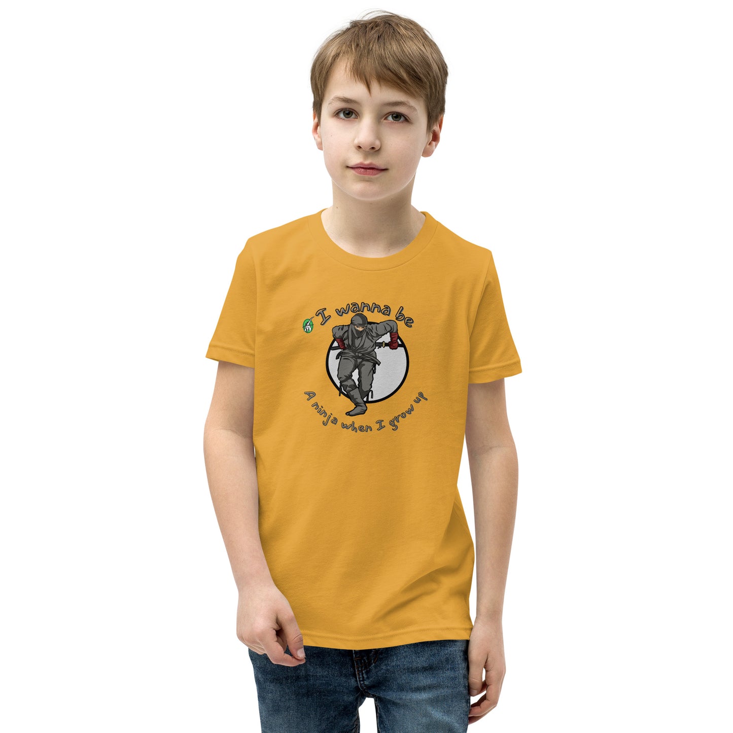 A boy standing wearing a mustard kids graphic tee shirt with a ninja and the words I wanna be a ninja when I grow up, by Wizard Prints