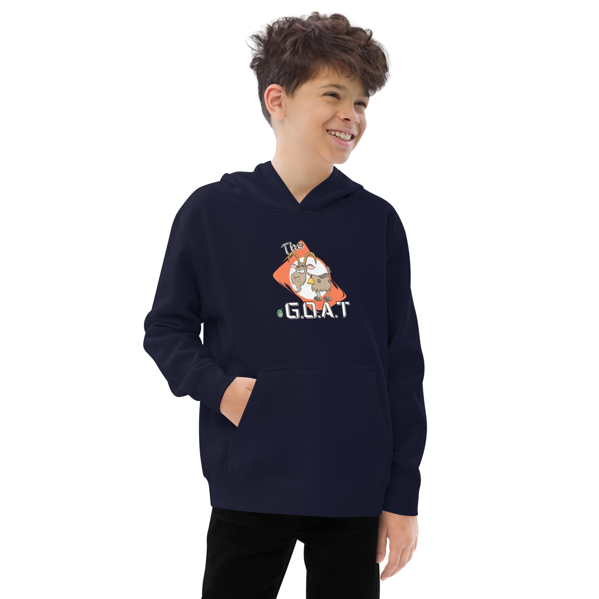 A boy standing wearing a navy kids hoodie with a graphic of a goat with the word G.O.A.T as in Greatest of all Time by Wizard Prints and jeans on a grey background