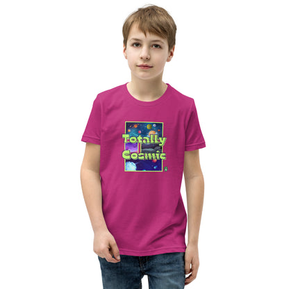A boy standing wearing a pink kids t-shirt with a graphic of the cosmos and the words Totally Cosmic, by Wizard Prints