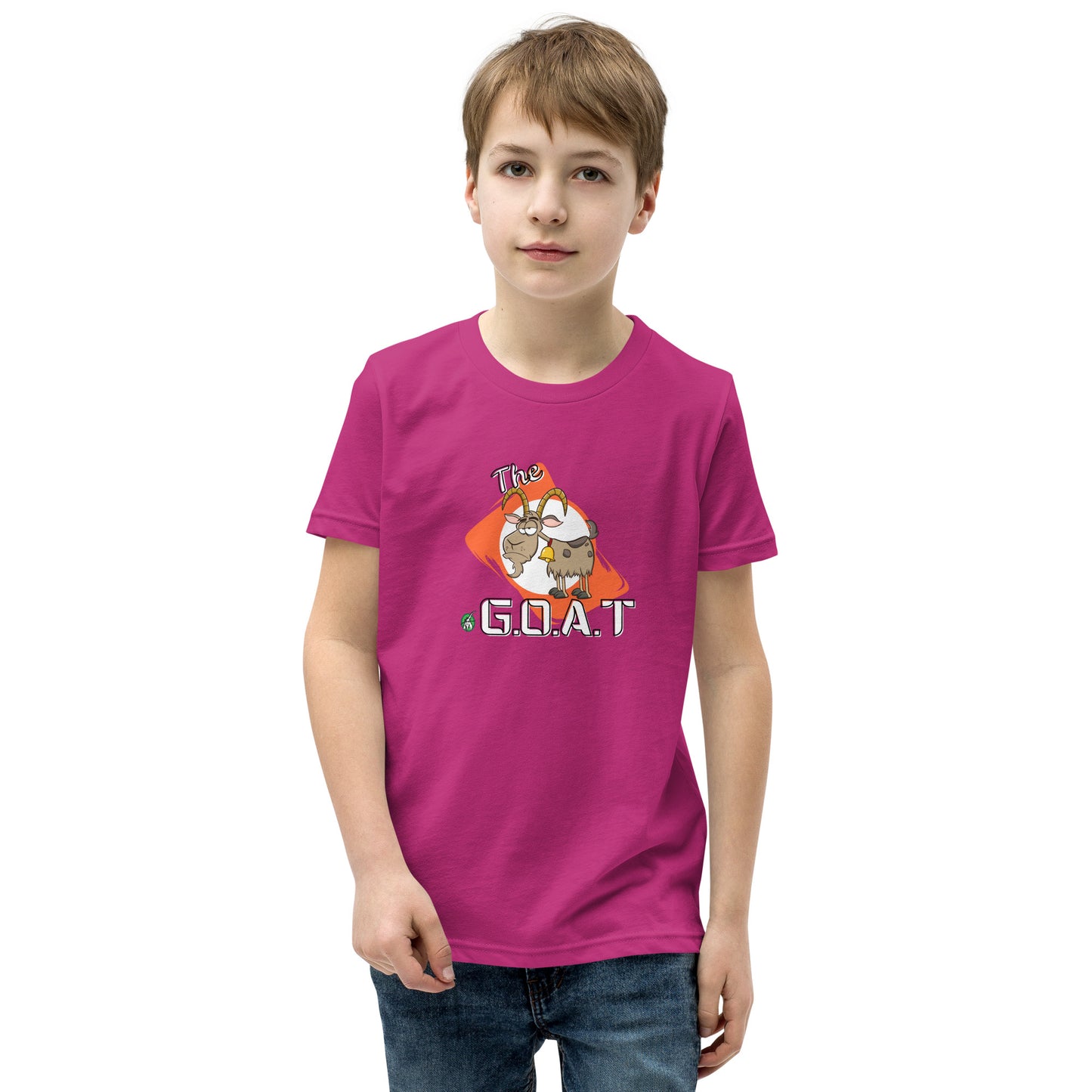 A boy standing wearing a pink kids tee shirt with a graphic of a goat with the word G.O.A.T as in Greatest of all Time by Wizard Prints and jeans on a white background
