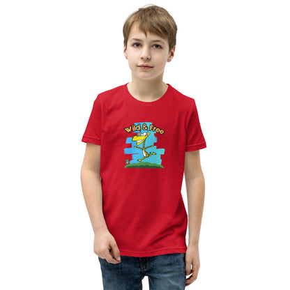 A boy standing wearing a red t-shirt with a funny graphic on the front of a giraffe running with the words, 'wild and free'  by Wizard Prints