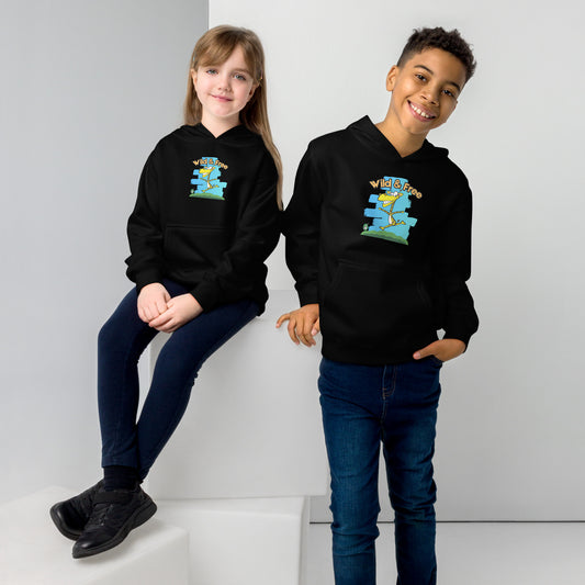 A boy standing and a girl sitting wearing a black hoodie with a funny graphic on the front of a giraffe running with the words, 'wild and free' by Wizard Prints and jeans on a grey background 