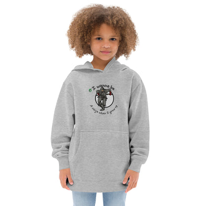 A girl standing wearing a white kids graphic hoodie with a ninja and the words I wanna be a ninja when I grow up, by Wizard Prints