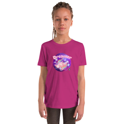  A girl standing wearing a berry pink kids t-shirt with the printed graphic of a galaxy and the word, Dreamer, by Wizard Prints