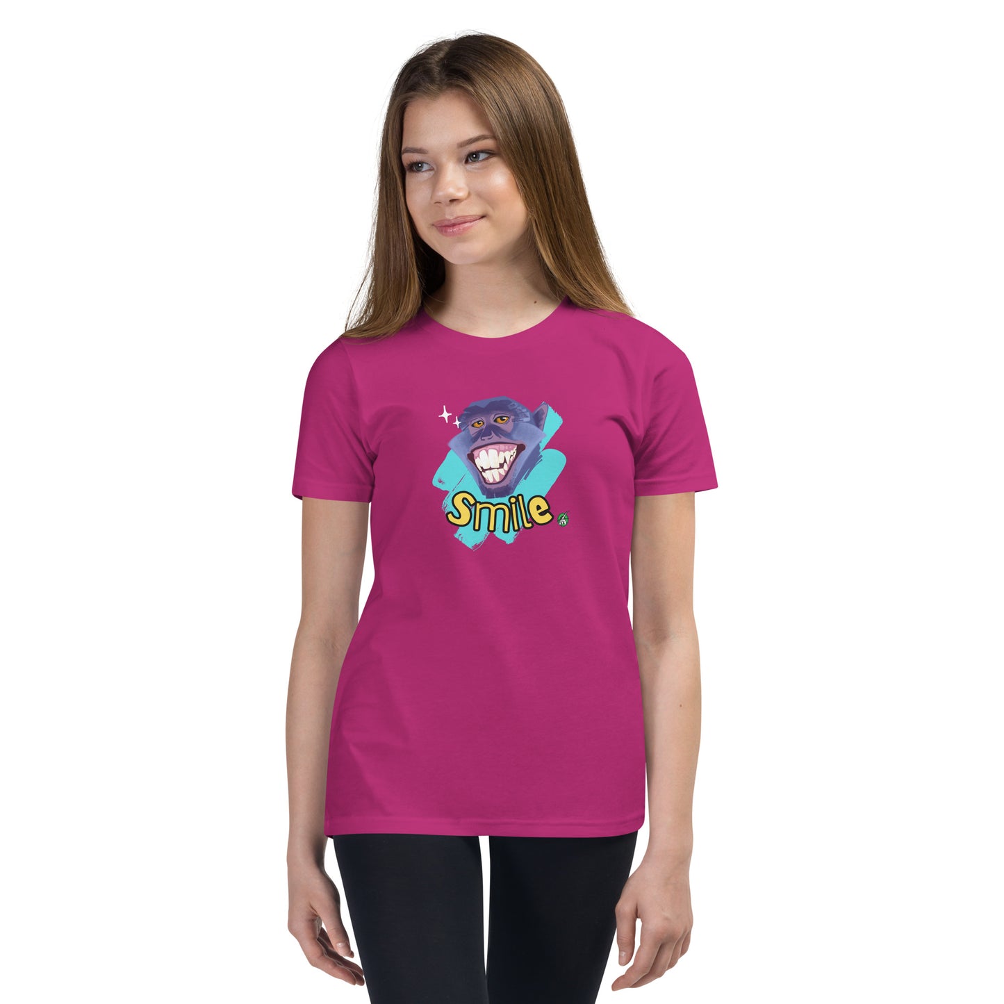  A girl standing wearing a berry pink kids t-shirt with the printed graphic of a smiling monkey and the word, Smile. Designed by Wizard Prints