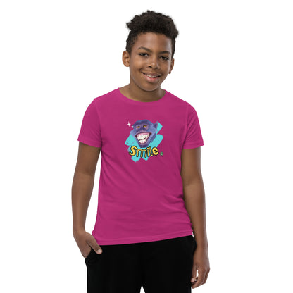  A boy standing wearing a berry pink kids t-shirt with the printed graphic of a smiling monkey and the word, Smile. Designed by Wizard Prints