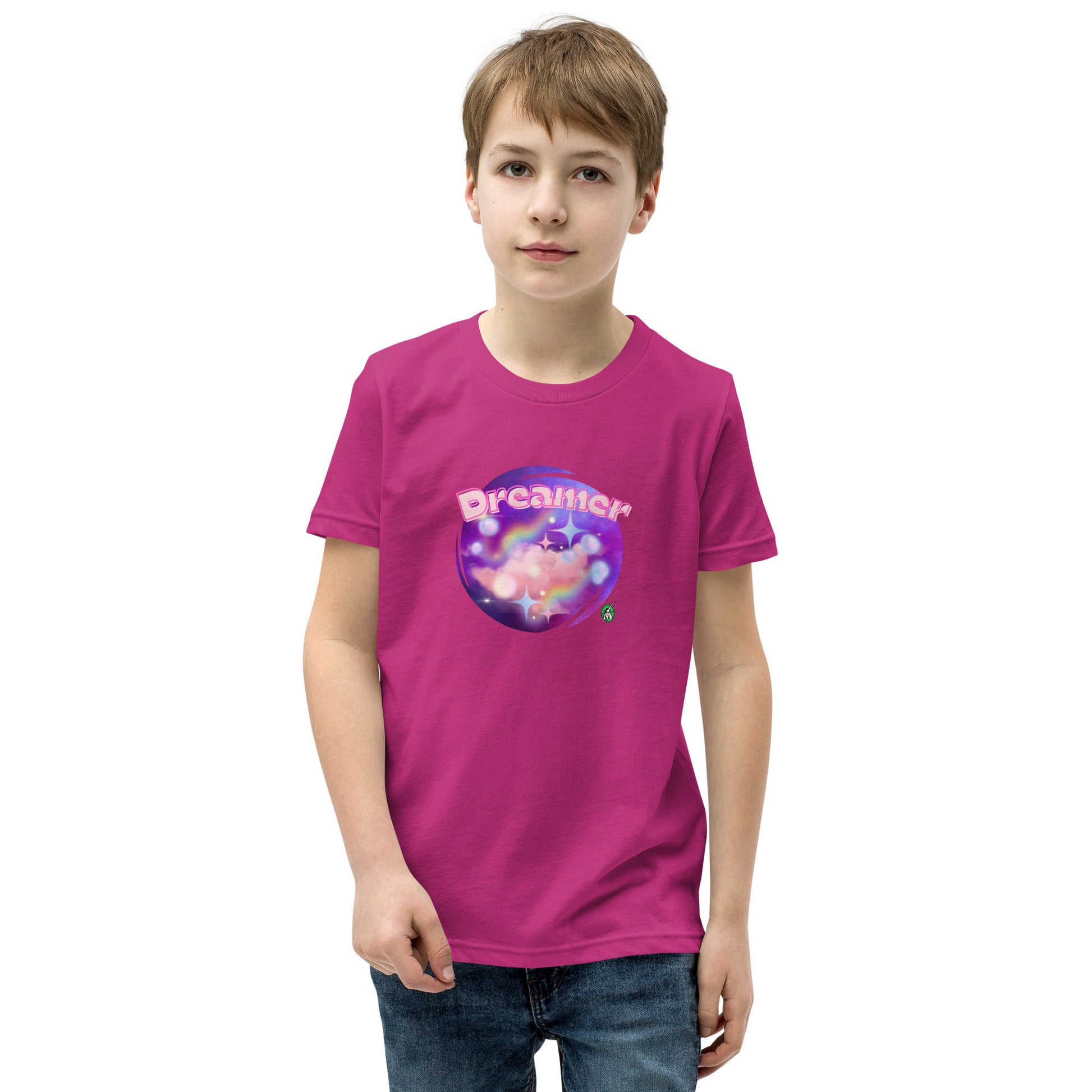  A boy standing wearing a berry pink kids t-shirt with the printed graphic of a galaxy and the word, Dreamer, by Wizard Prints