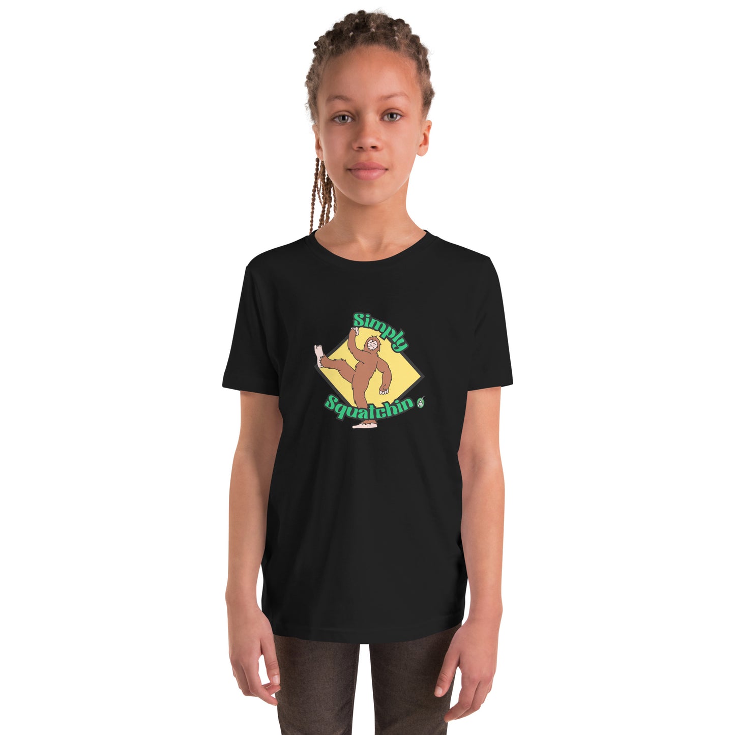 A girl standing wearing a black graphic t-shirt with a brown sasquatch and the statement, Simply Squatchin on a yellow background, by Wizard Prints