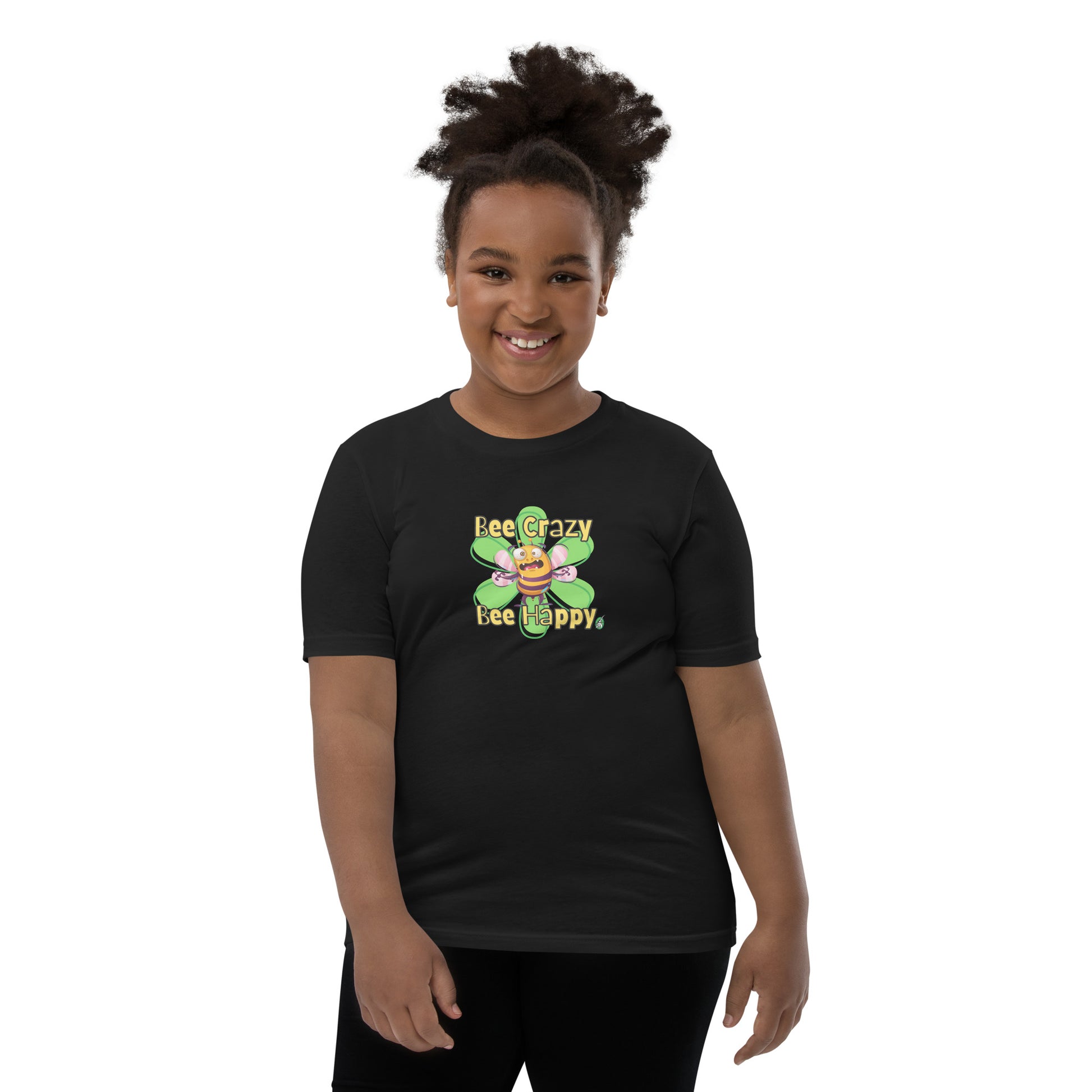  A girl standing wearing a black kids t-shirt with the printed graphic of a crazy bee and the statement, Bee Crazy Bee Happy. Designed by Wizard Prints