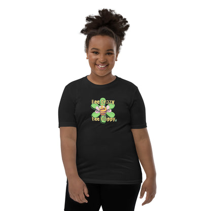  A girl standing wearing a black kids t-shirt with the printed graphic of a crazy bee and the statement, Bee Crazy Bee Happy. Designed by Wizard Prints
