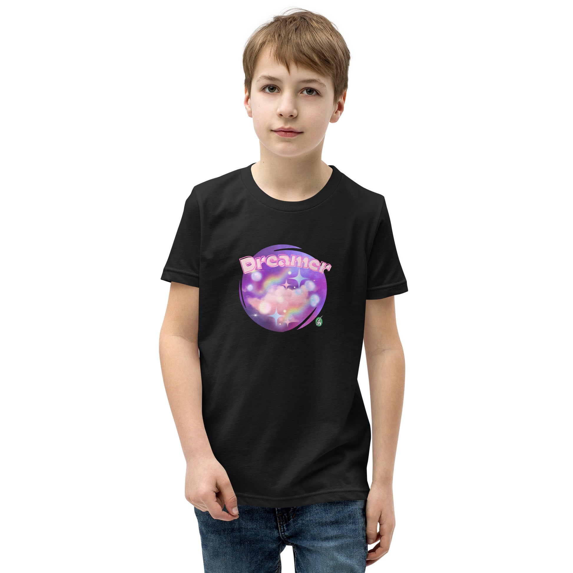  A boy standing wearing a black kids t-shirt with the printed graphic of a galaxy and the word, Dreamer, by Wizard Prints