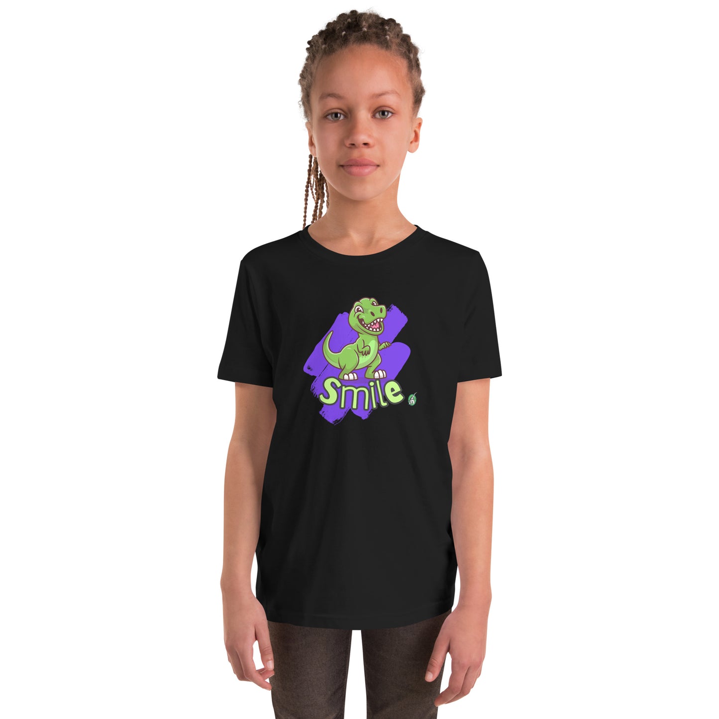 A girl standing wearing a black kids t-shirt with the printed graphic of a cartoon dinosaur and the word, Smile. Designed by Wizard Prints