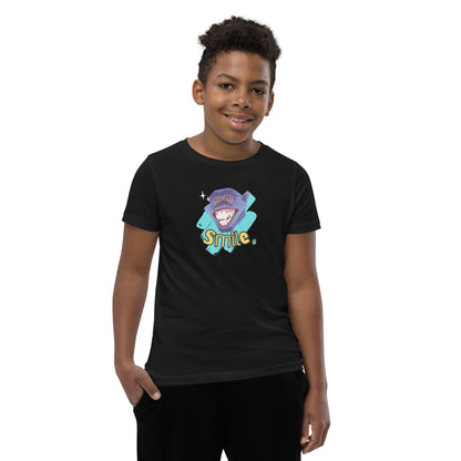  A boy standing wearing a black kids t-shirt with the printed graphic of a smiling monkey and the word, Smile. Designed by Wizard Prints