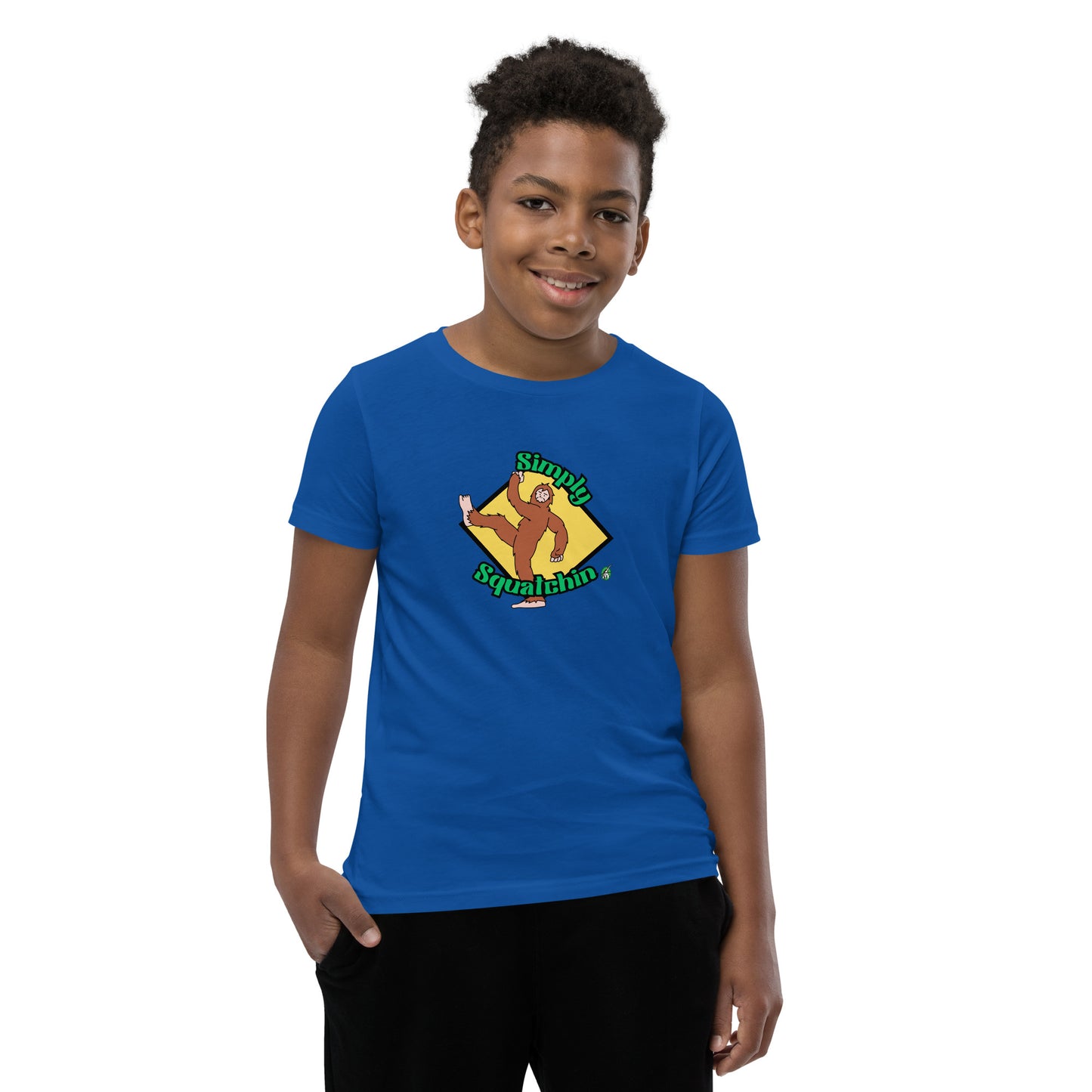 A boy standing wearing a blue graphic t-shirt with a brown sasquatch and the statement, Simply Squatchin on a yellow background, by Wizard Prints