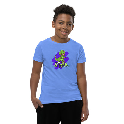  A boy standing wearing a blue kids t-shirt with the printed graphic of a cartoon dinosaur and the word, Smile. Designed by Wizard Prints