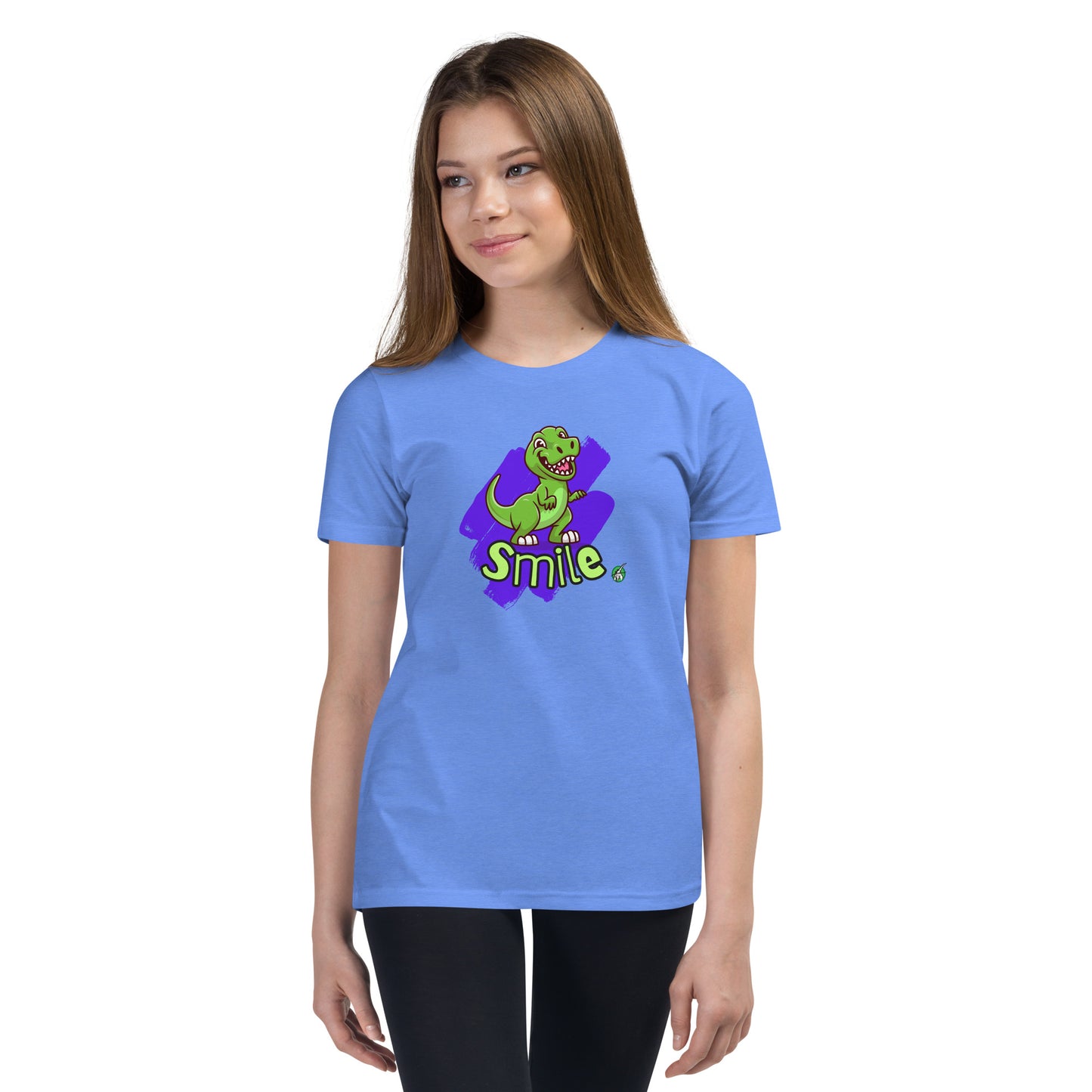  A girl standing wearing a blue kids t-shirt with the printed graphic of a cartoon dinosaur and the word, Smile. Designed by Wizard Prints