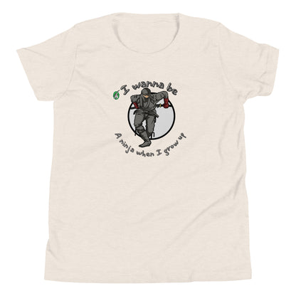 A cream kids graphic tee shirt with a ninja and the words I wanna be a ninja when I grow up, by Wizard Prints