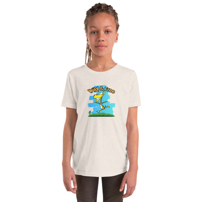 A girl standing wearing a cream t-shirt with a funny graphic on the front of a giraffe running with the words, 'wild and free'  by Wizard Prints