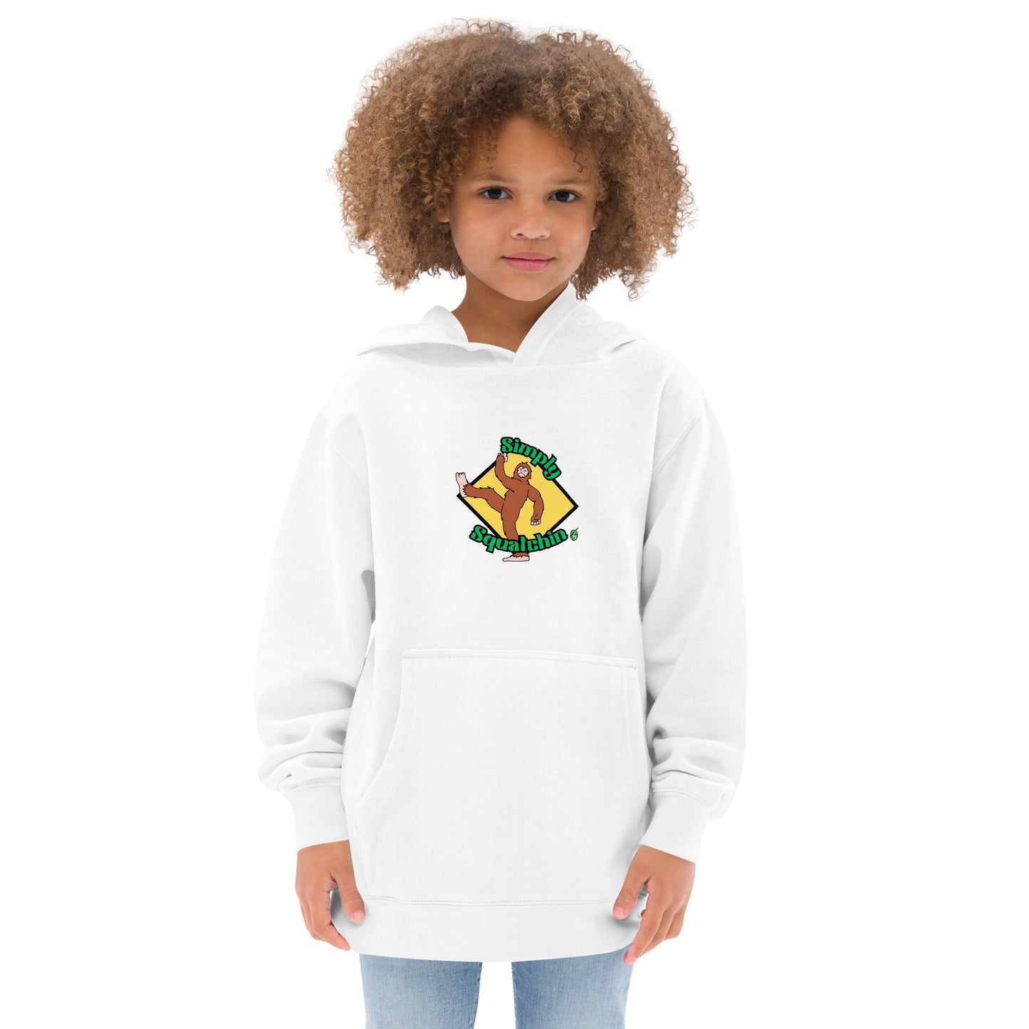 A girl standing wearing a white kids graphic hoodie with a brown sasquatch and the statement, Simply Squatchin on a yellow background, by Wizard Prints