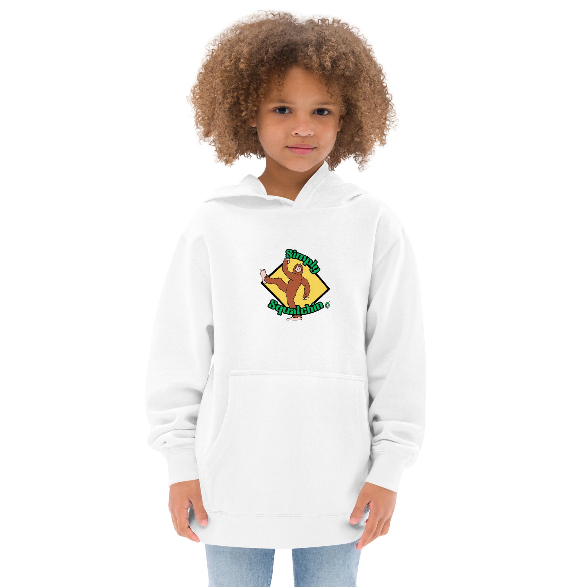 A girl standing wearing a white kids graphic hoodie with a brown sasquatch and the statement, Simply Squatchin on a yellow background, by Wizard Prints