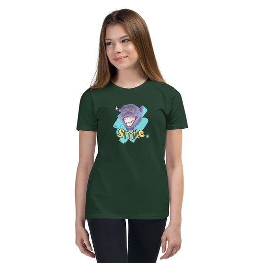 A girl standing wearing a forest green kids t-shirt with the printed graphic of a smiling monkey and the word, Smile. Designed by Wizard Prints